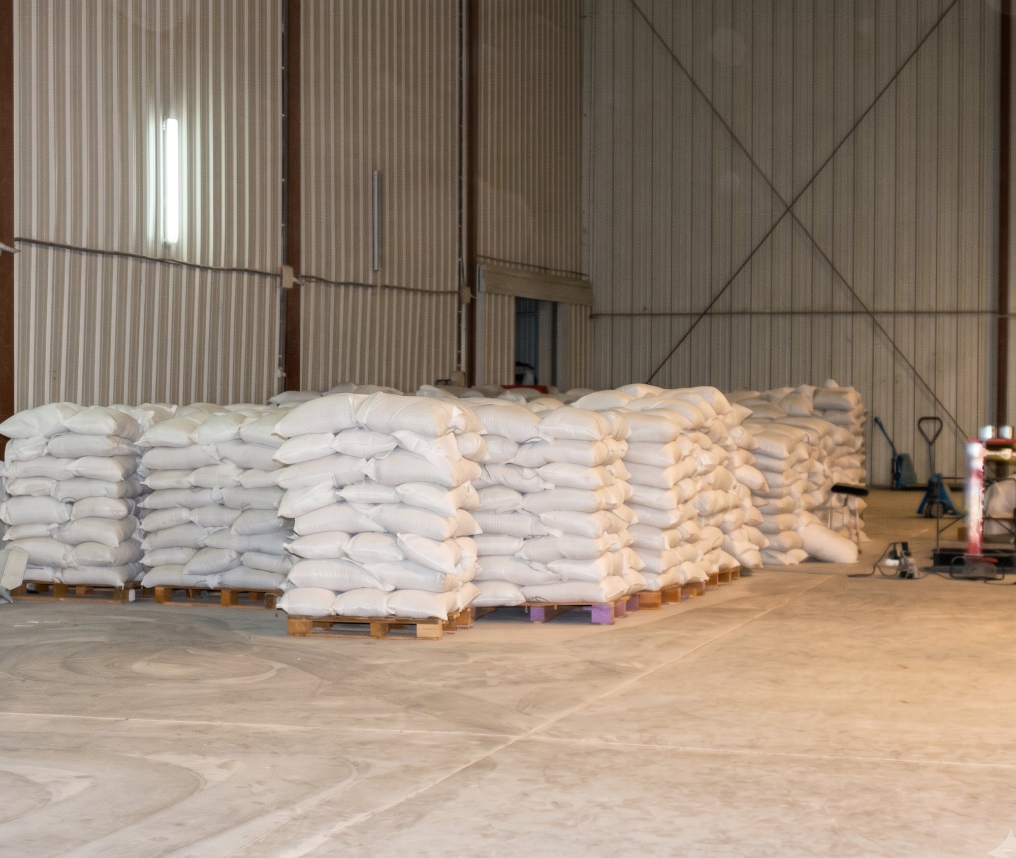 Palletized 25 and 50 kg export bags of gum arabic stacked in an origin warehouse